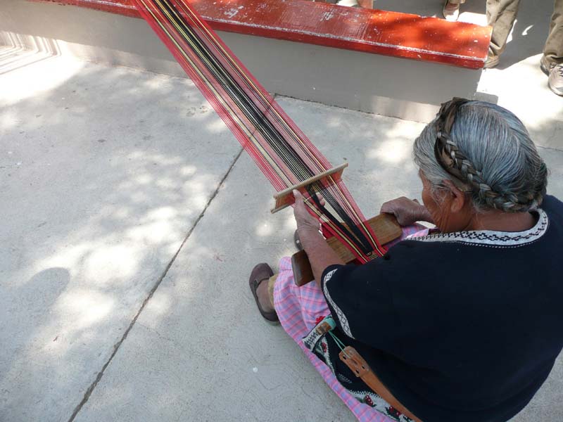 A back strap weaver working